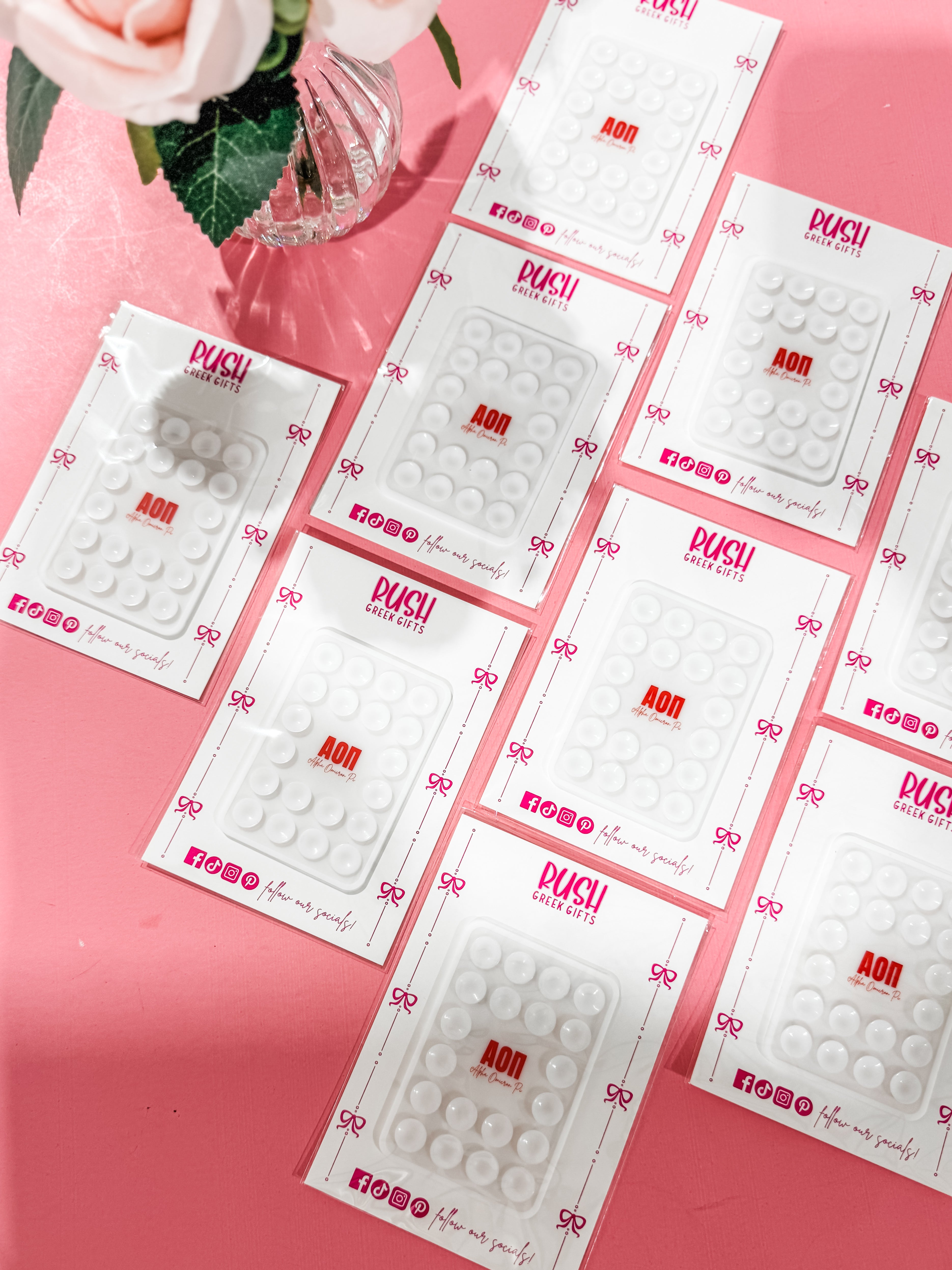 Multiple packages of a suction phone accessory for the Alpha Omicron Pi sorority.